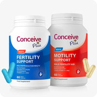 Conceive Plus Motility Bundle featuring two male fertility supplement bottles—Men's Fertility Support in blue and Men's Motility Support in red—displayed upright on a white background, with matching blue and beige capsules placed near each bottle to visually highlight product contents and color-coded design for easy recognition.