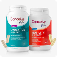 Conceive Plus Motility & Ovulation Support Bundle featuring two supplement bottles—teal for Women's Ovulation Support and red for Men's Motility Support—displayed upright with floating capsules around them, highlighting gender-specific fertility support with white background.