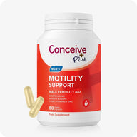 Conceive Plus Motility Support Supplement men's fertility capsules in a white and red branded bottle, with two yellow vegan capsules displayed beside the container, designed to boost motility and sperm count, shown on a white background for clear product visibility.